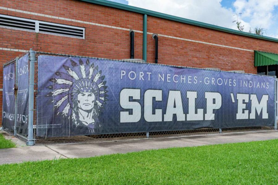 Port Neches Groves High School displays a banner outside the school which includes the phrase, Scalp Em, a line from their school song. 