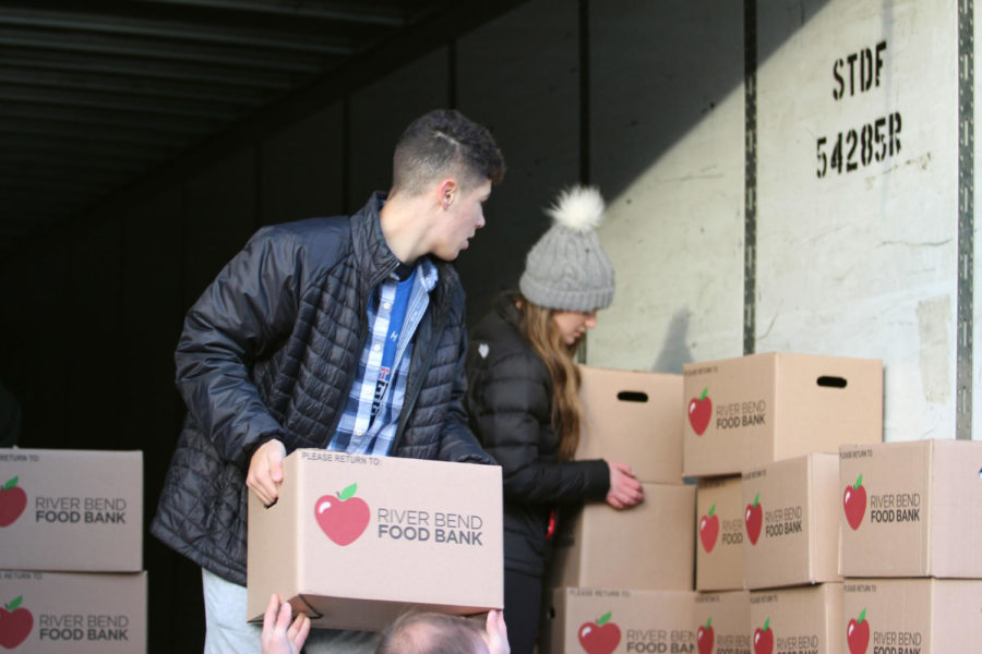Charlie Zimmerman helps load boxes of canned food during last years loading day. Last years hunger drive raised a total of 53,000 pounds of food. 