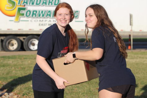 Eva Fiedler and Claire Franzman use teamwork to help load the truck on loading day. 