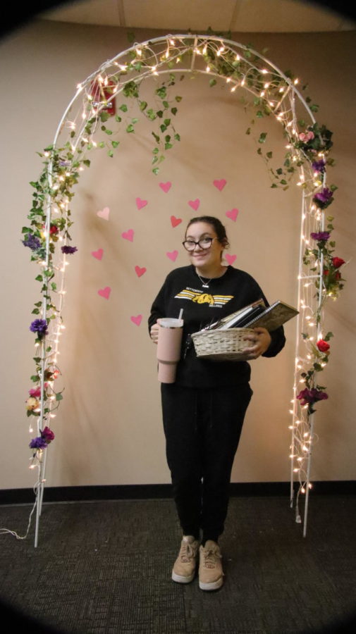 Senior Loukia Constantinides takes a moment to showcase the photo booth for Spread the Love Week. Constantinides was the committee chair for Spread the Love Week. 