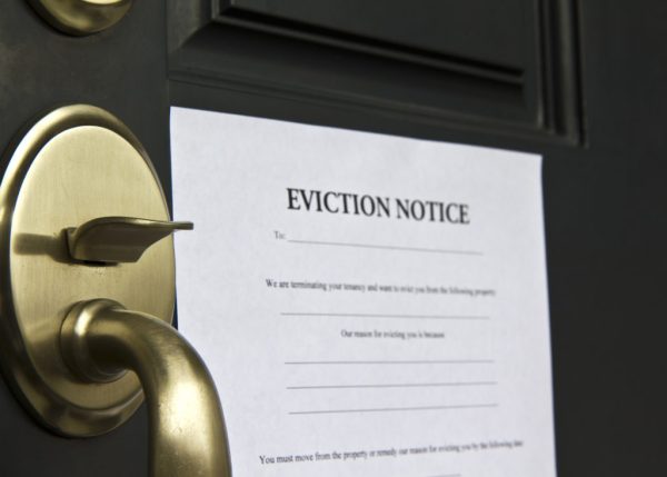 Eviction notice letter pasted on front door of house